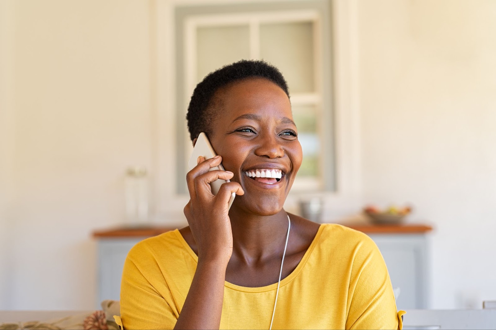 A young woman is on the phone with her relative that has dementia.